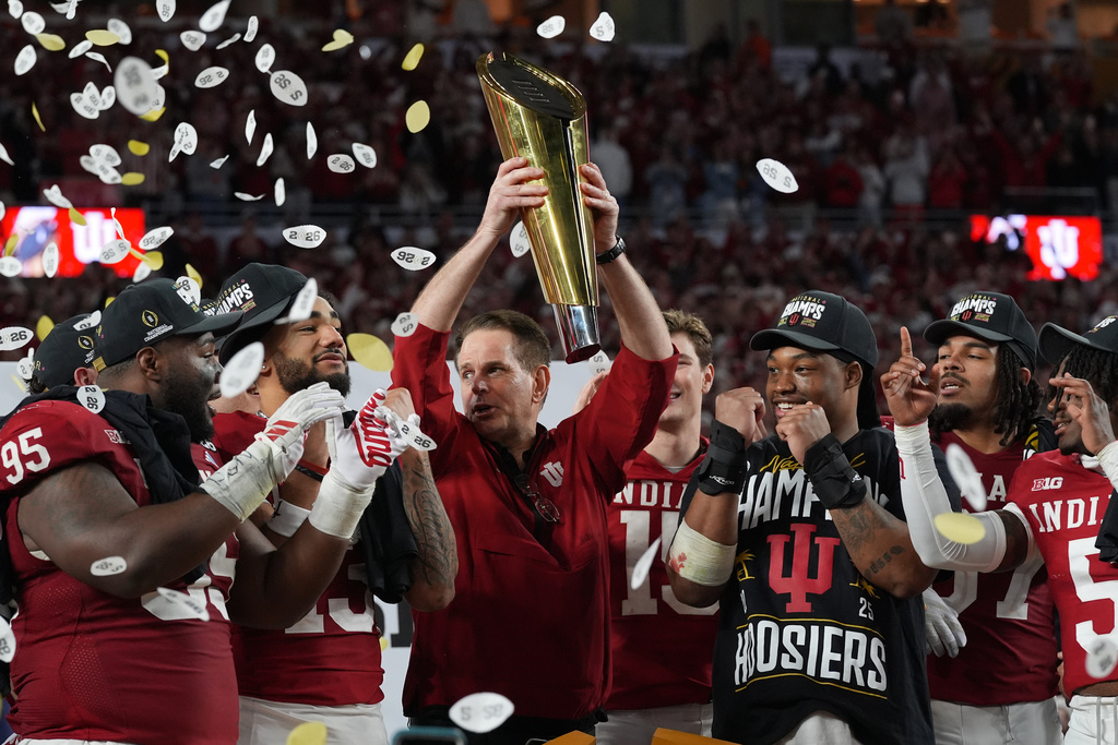 Indiana head coach Curt Cignetti lifts the College Football Playoff trophy after defeating Miami in the College Football Playoff national championship game, Tuesday, Jan. 20, 2026, in Miami Gardens, Fla.