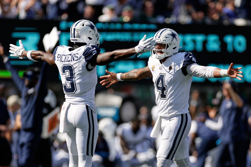 Dallas Cowboys' Dak Prescott celebrates with George Pickens after a touchdown during the first half of an NFL football game against the New York Jets Sunday, Oct. 5, 2025, in East Rutherford, N.J.