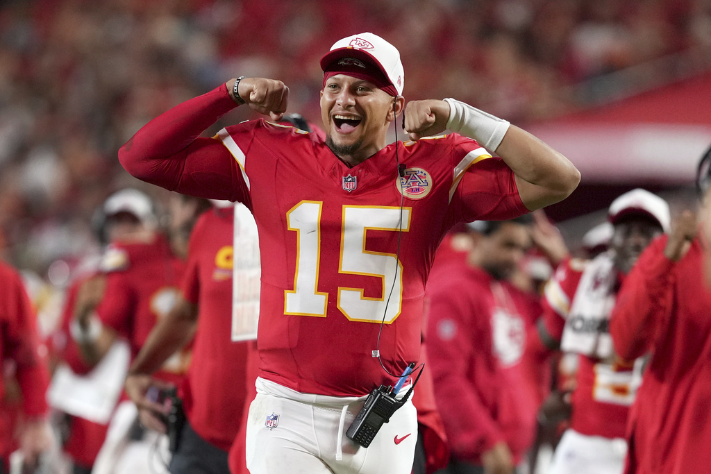 Chiefs QB Patrick Mahomes cheers from the sidelines during a preseason game vs. the Bears.