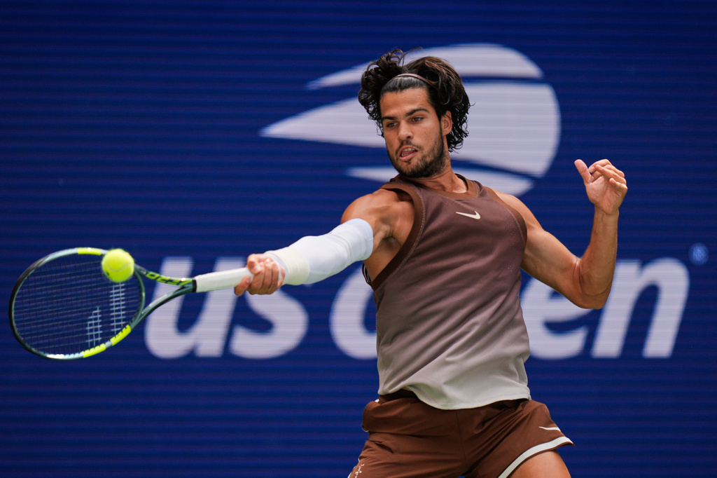 Carlos Alcaraz returns the ball to Roman Safiullin during the first round of the US Open.