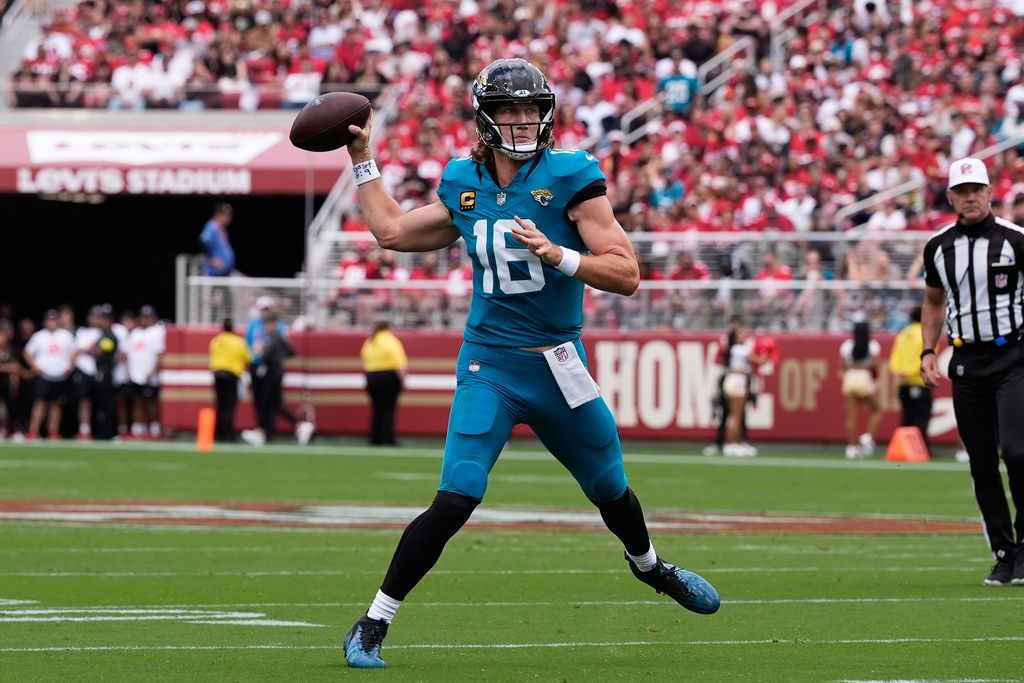 Jaguars QB Trevor Lawrence rolls out for a passing attempt vs. the 49ers.
