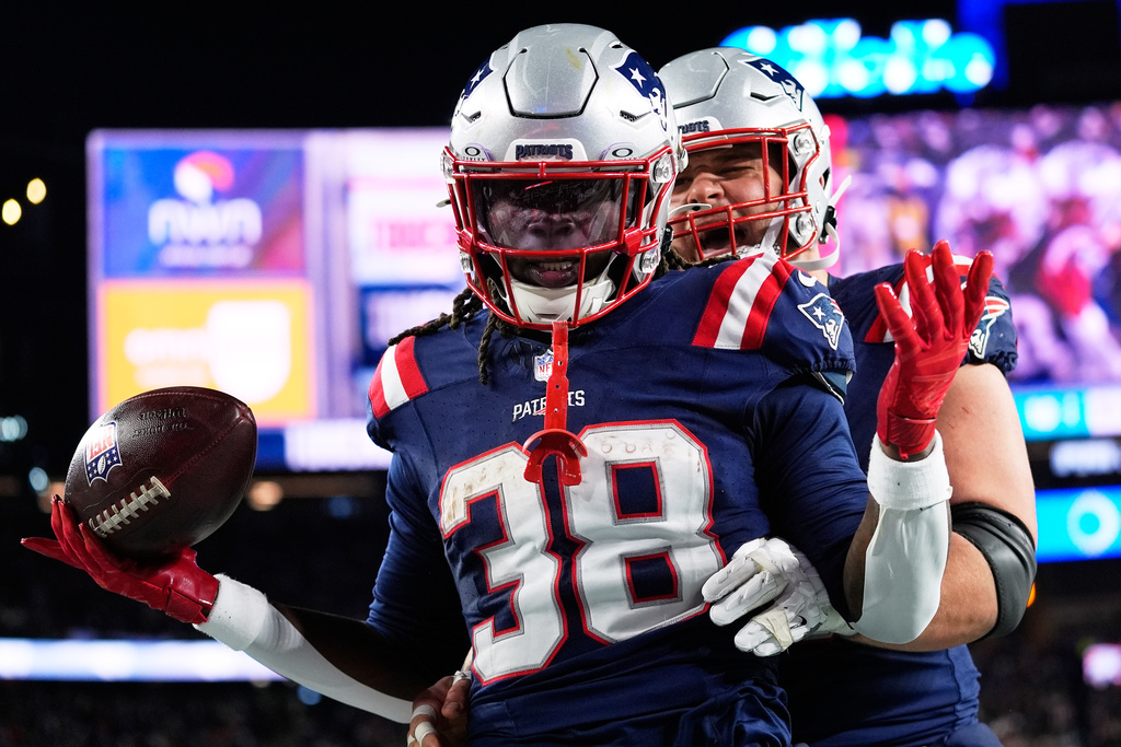 New England Patriots running back Rhamondre Stevenson celebrates after scoring a touchdown during the second half of an NFL football game.