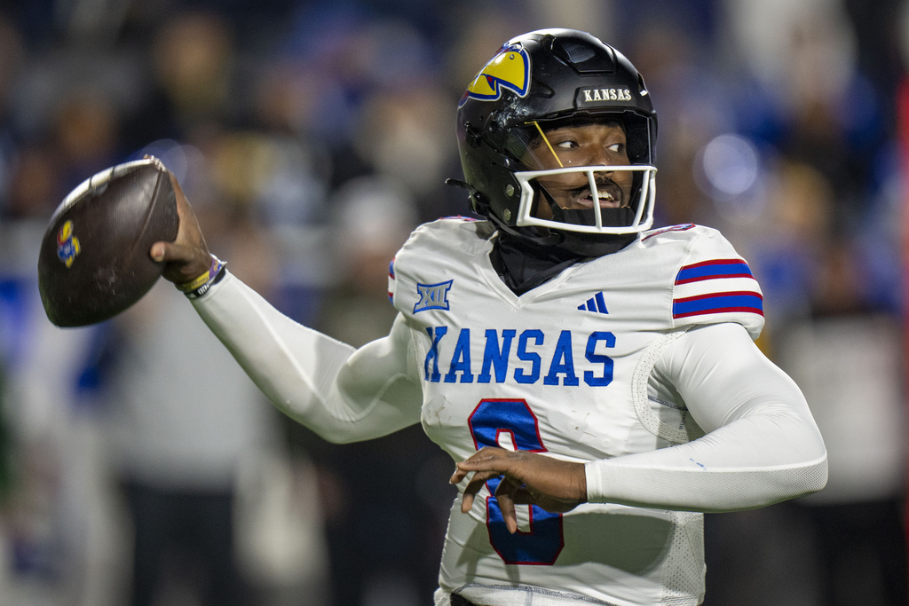 Kansas quarterback Isaiah Marshall throws a pass, during the first half of an NCAA college football game.