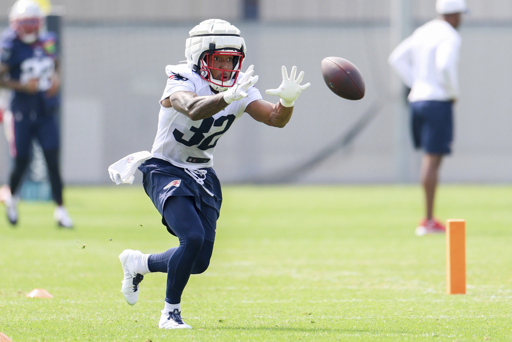 New England Patriots RB TreVeyon Henderson runs during a summer practice.