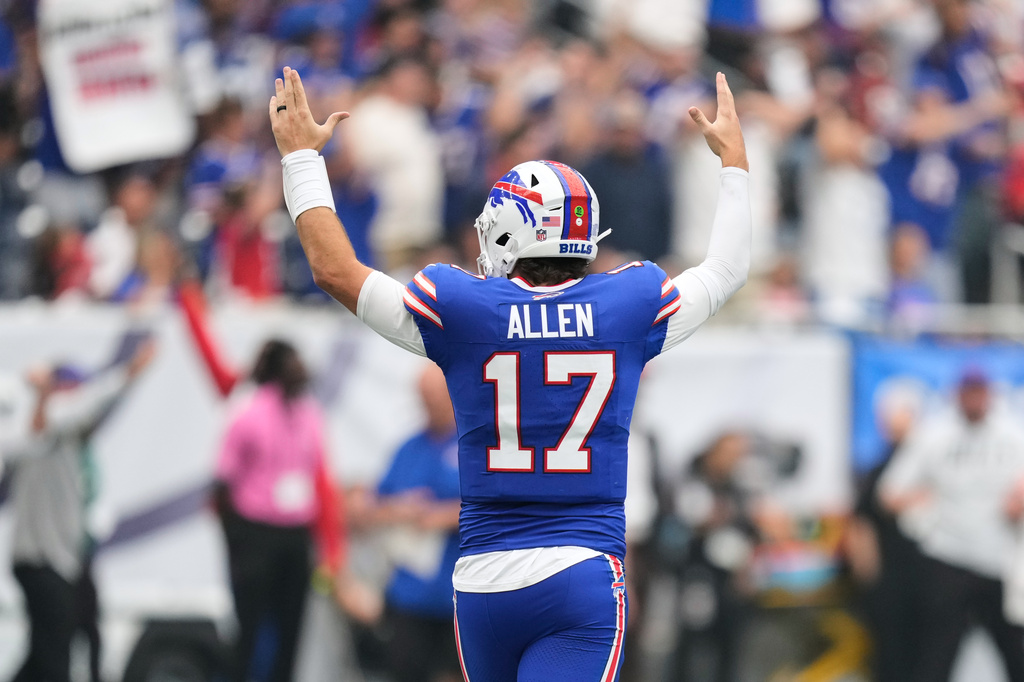 Buffalo Bills quarterback Josh Allen (17) reacts after wide receiver DJ Moore scored a touchdown during the first half of an NFL football game against the Houston Texans, Sunday, Sept. 13, 2026, in Houston.