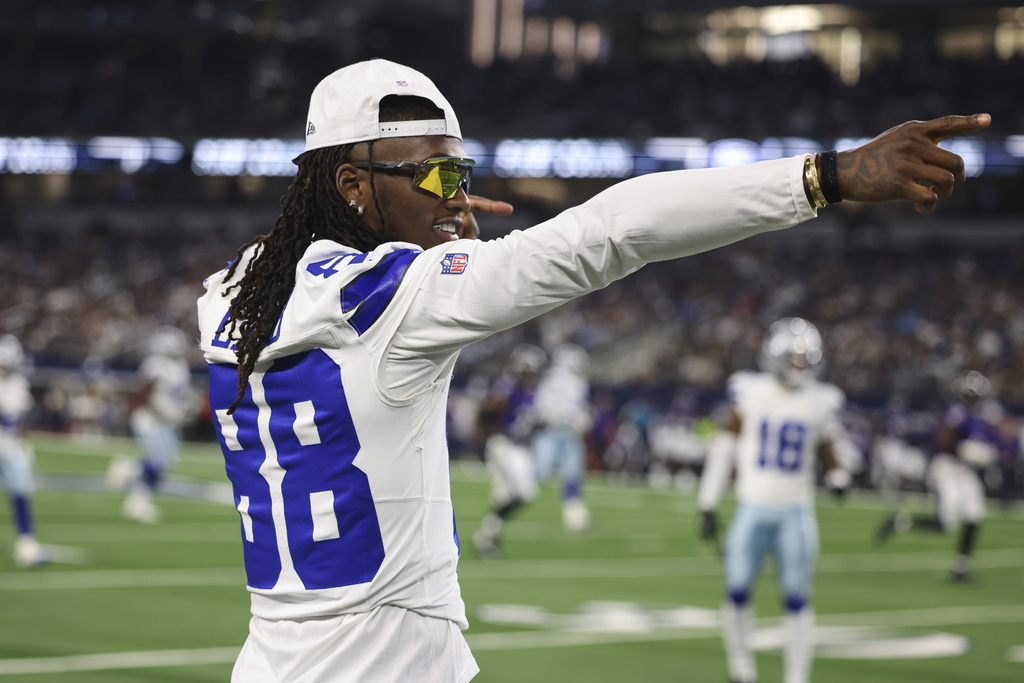 Cowboys WR CeeDee Lamb gestures for a first down on the sidelines during a game vs. the Ravens.