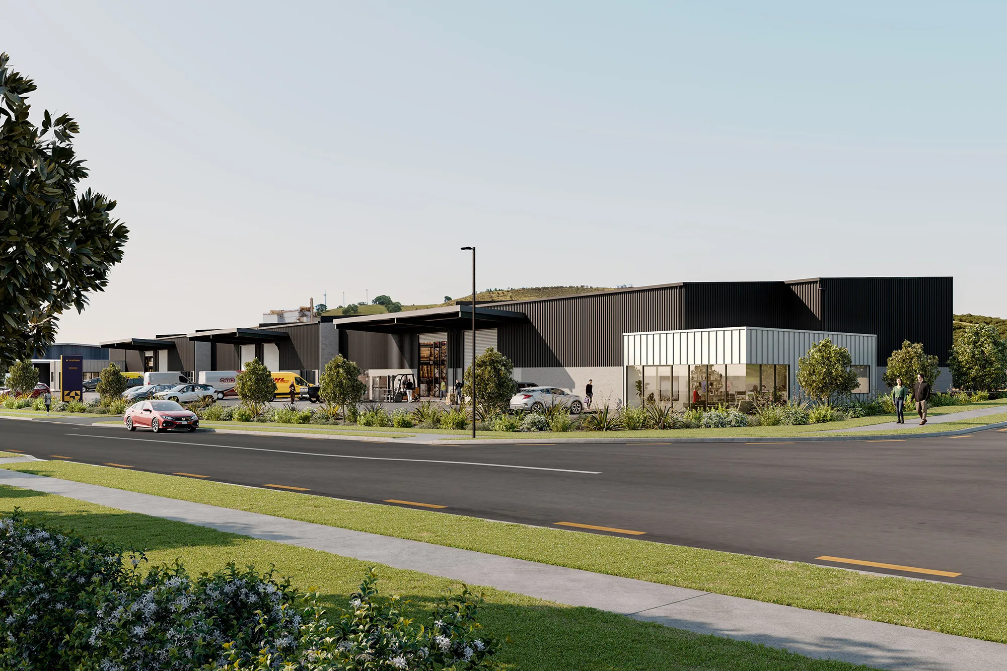 Modern industrial complex with multiple warehouse units, cars parked outside, and landscaped greenery under a clear sky.