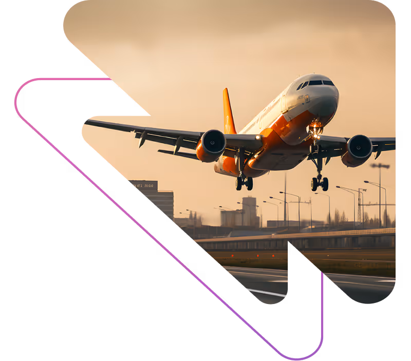 Commercial airplane with orange and white colors landing on a runway at sunset.