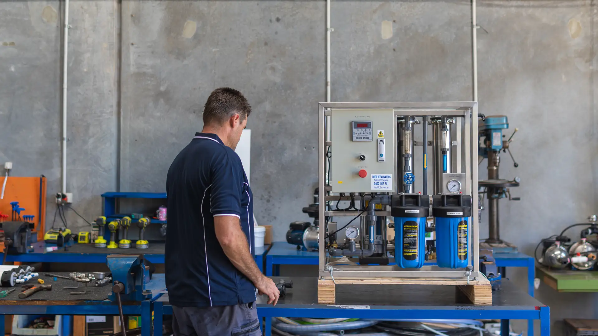 CITOR technician testing a reverse osmosis unit on the workshop bench