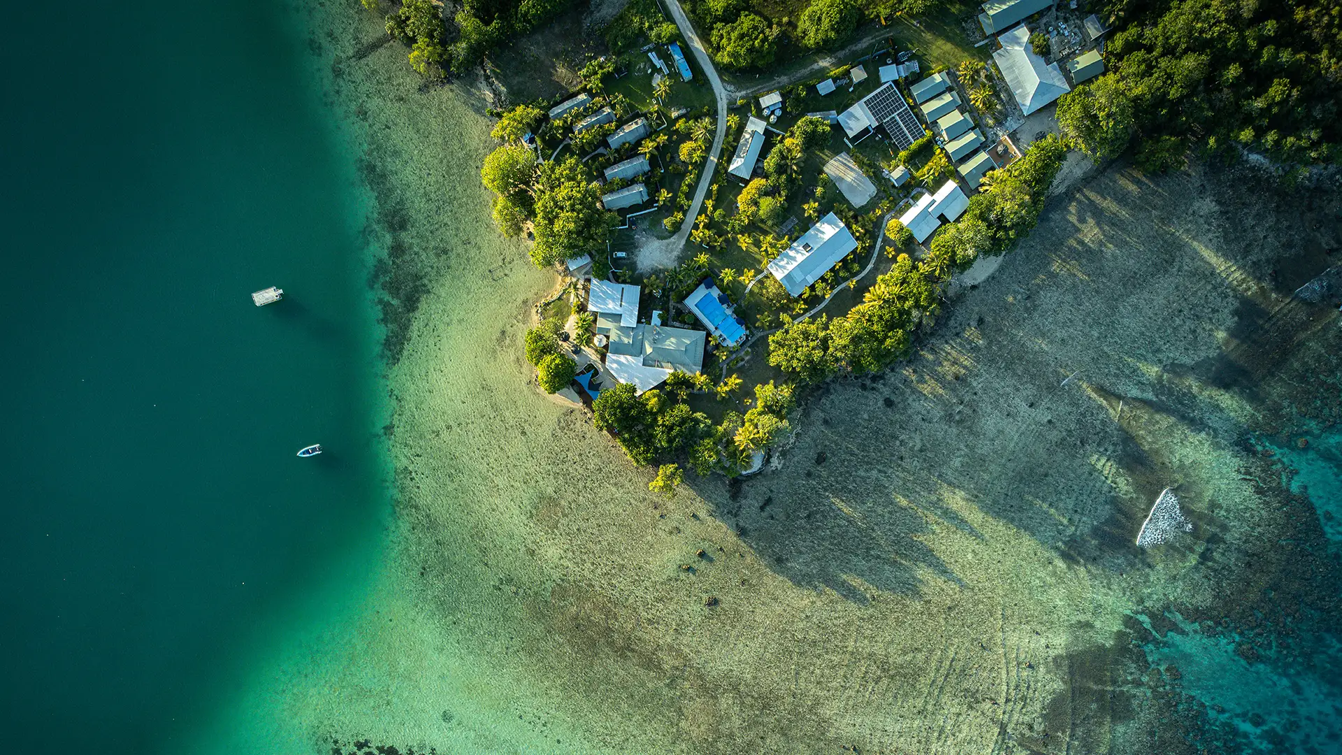 Aerial view of a remote island resort on a coral shoreline