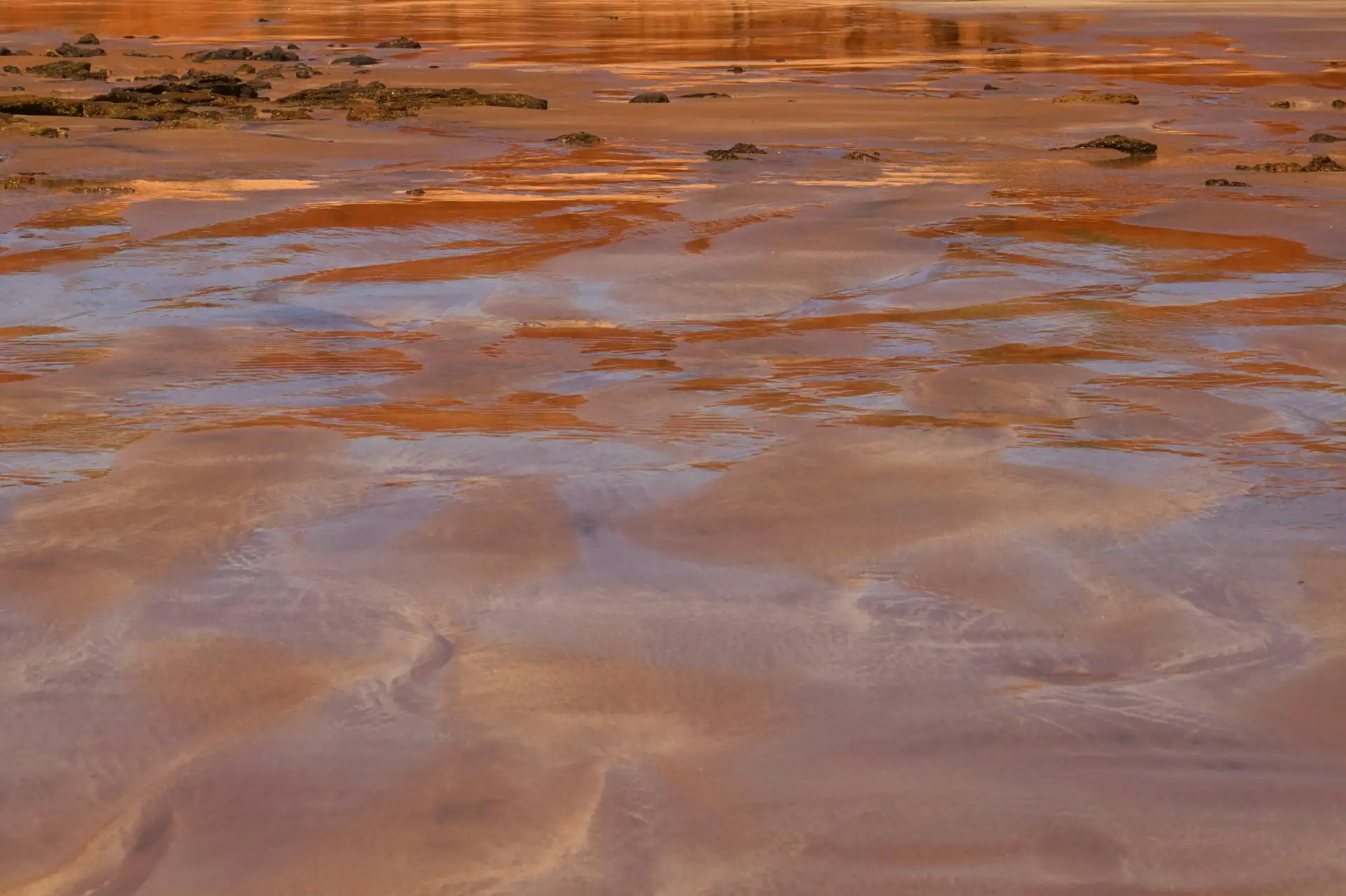 Aerial view of red and orange salt flats