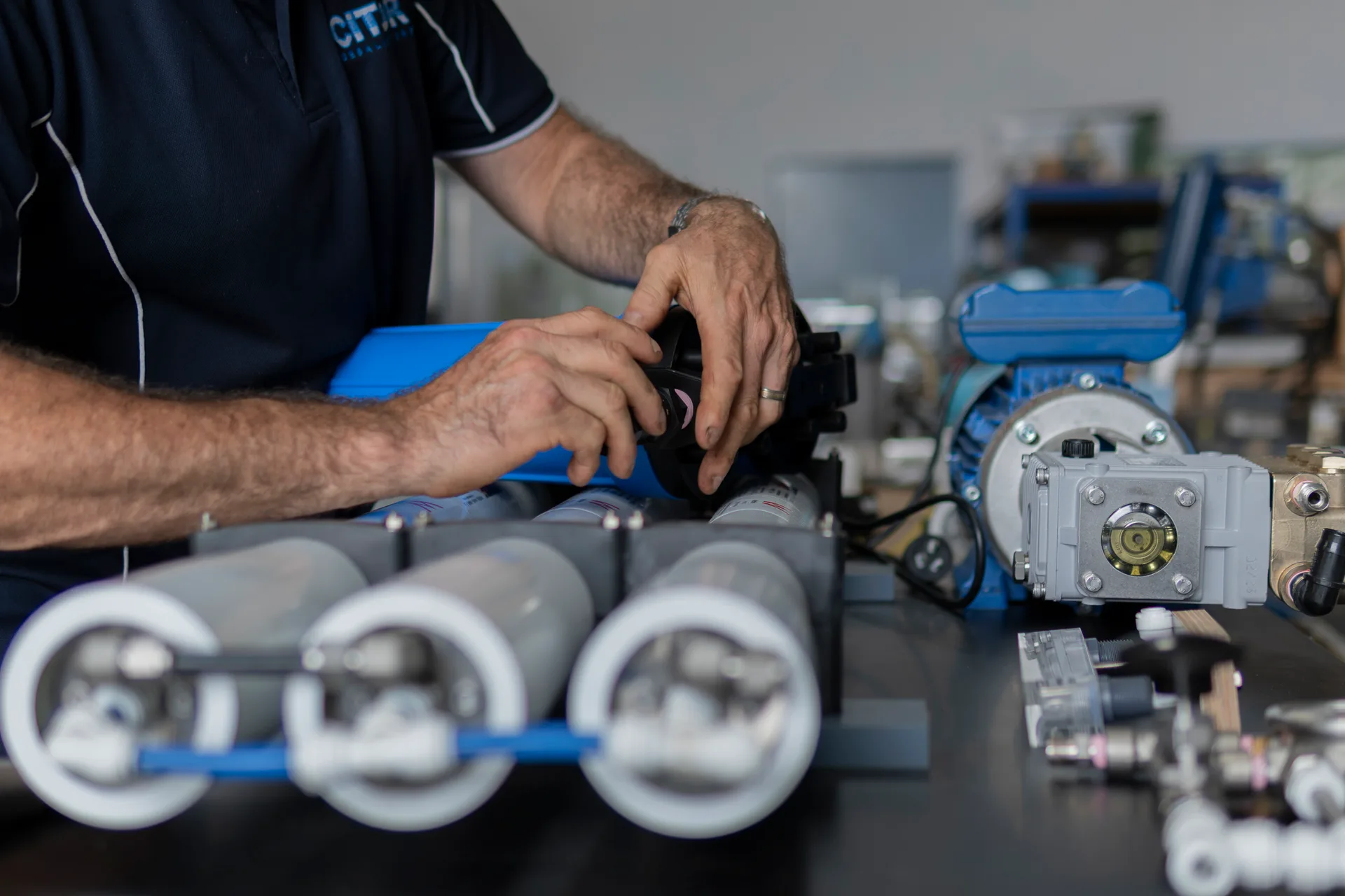 Engineer assembling a membrane housing manifold
