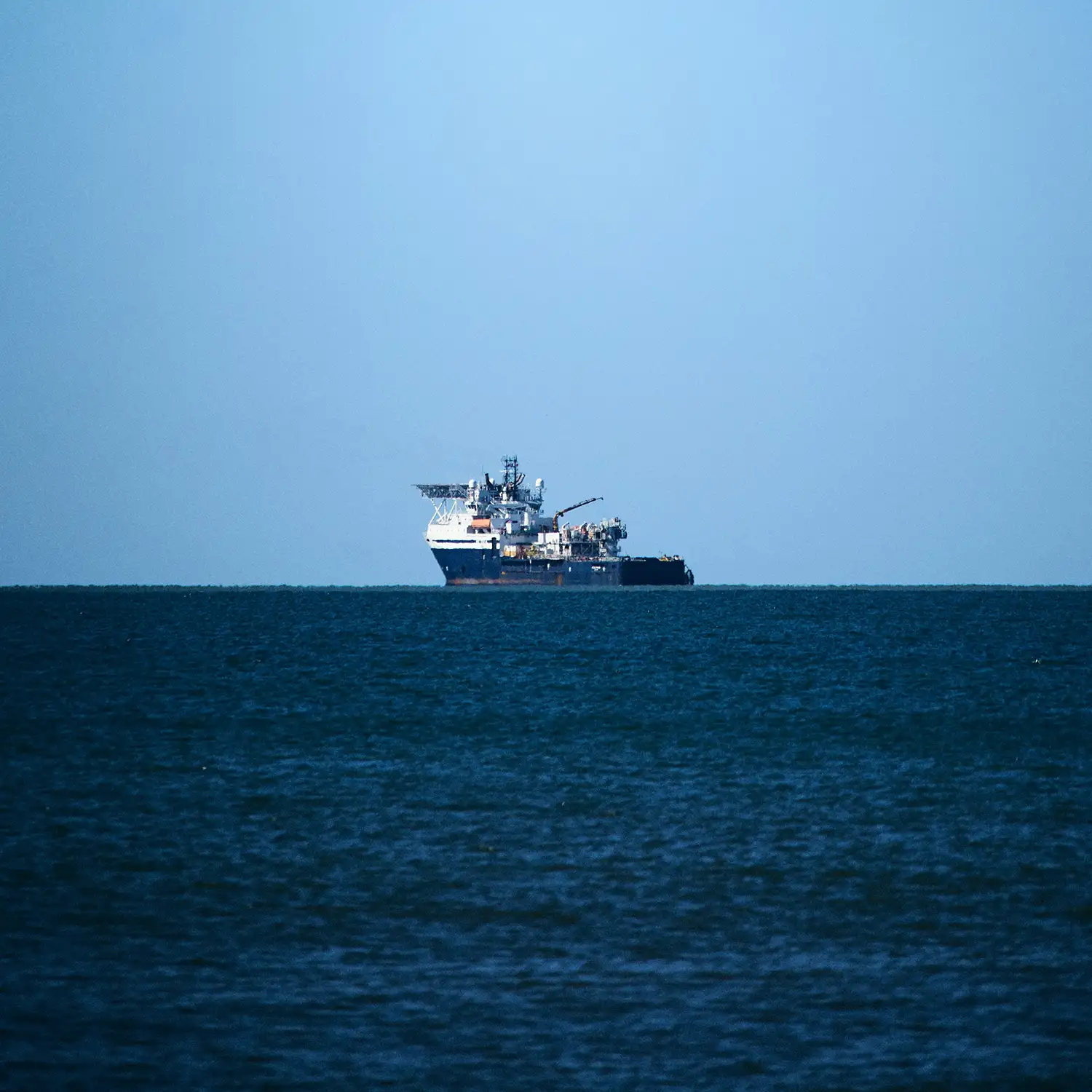 Commercial vessel on open blue ocean