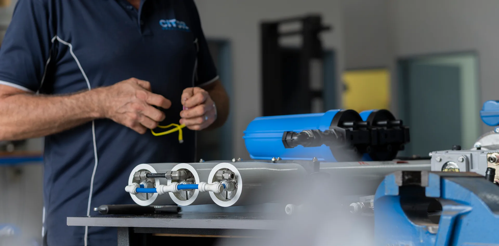 Technician preparing membrane housings on the workbench