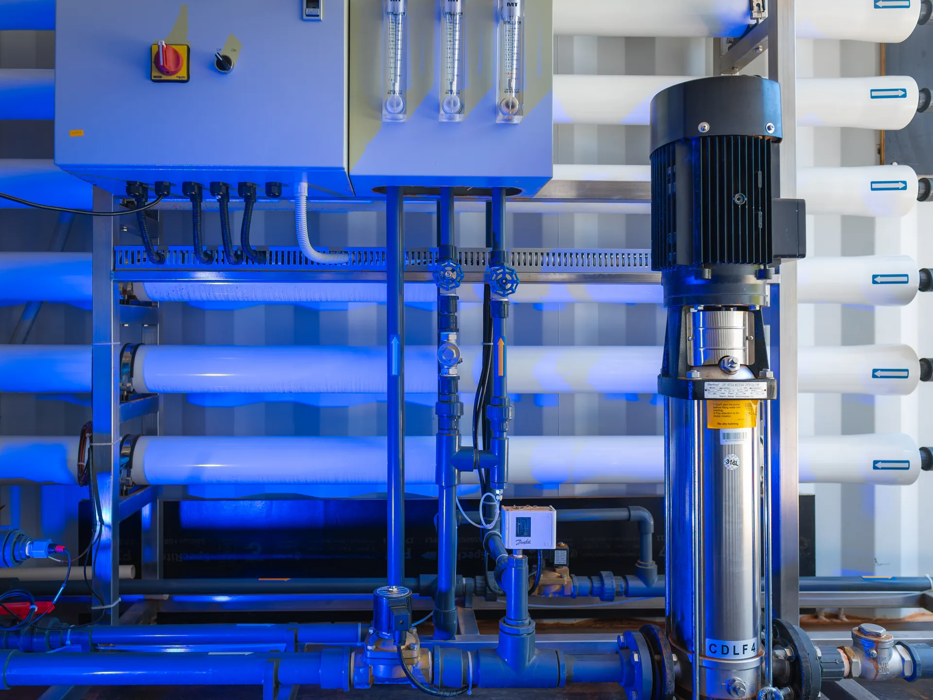 Custom CITOR reverse osmosis skid with blue membrane vessels, pump and control panel