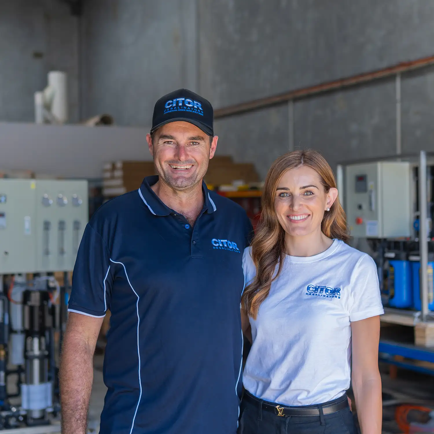 Two CITOR team members in branded shirts standing in the Perth workshop