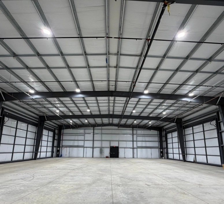 Interior of a large industrial building constructed by Supreme Construction with steel framing and open floor space.