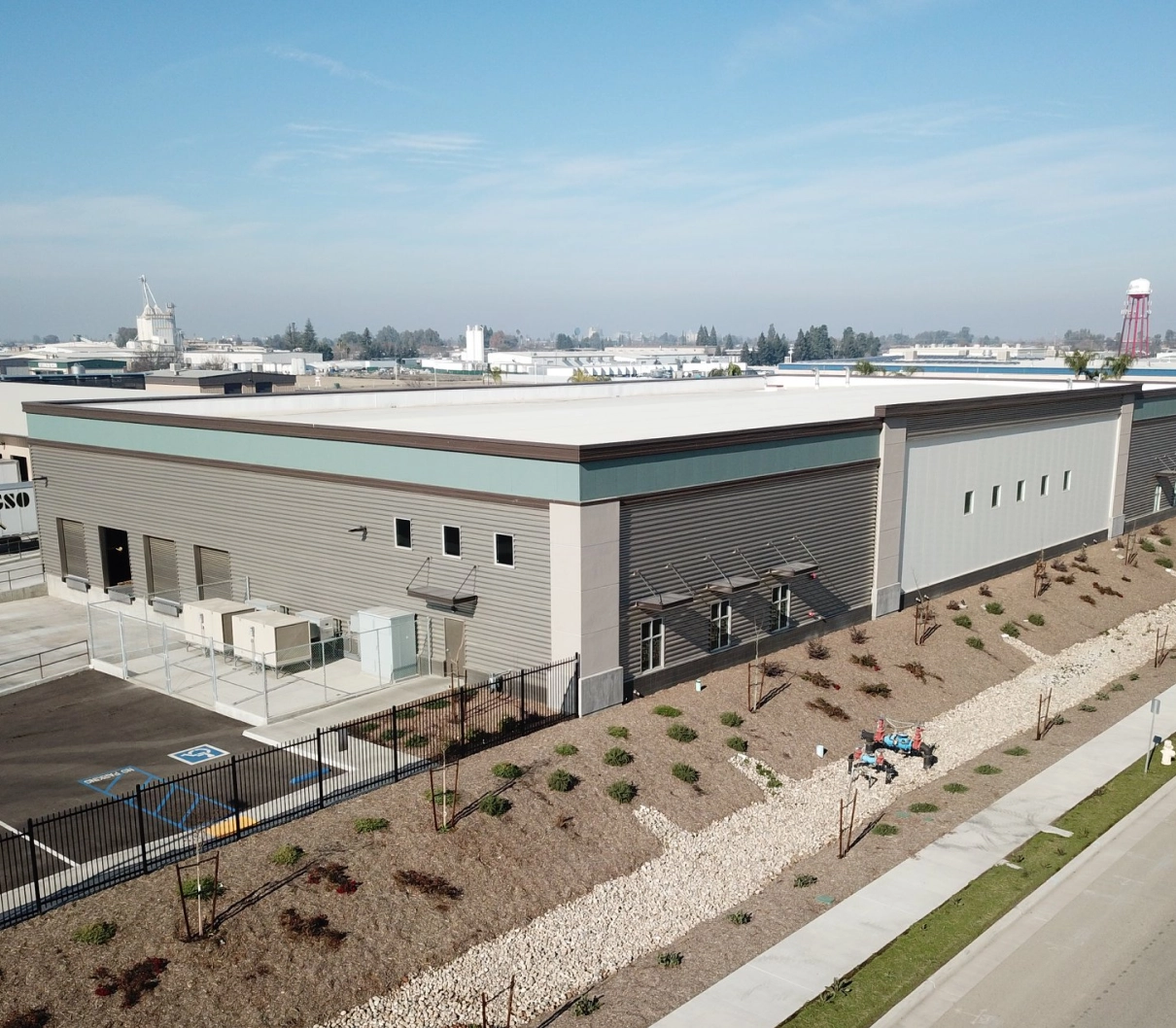 Supreme Construction commercial industrial building exterior with parking and landscaped grounds in California.
