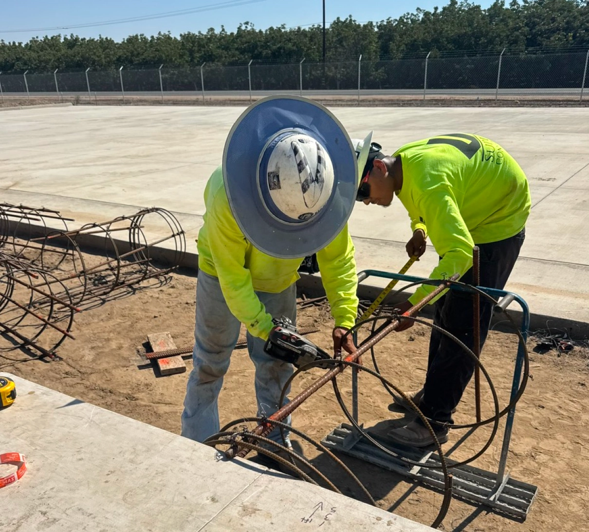 Construction worker installing rebar for a concrete foundation slab.