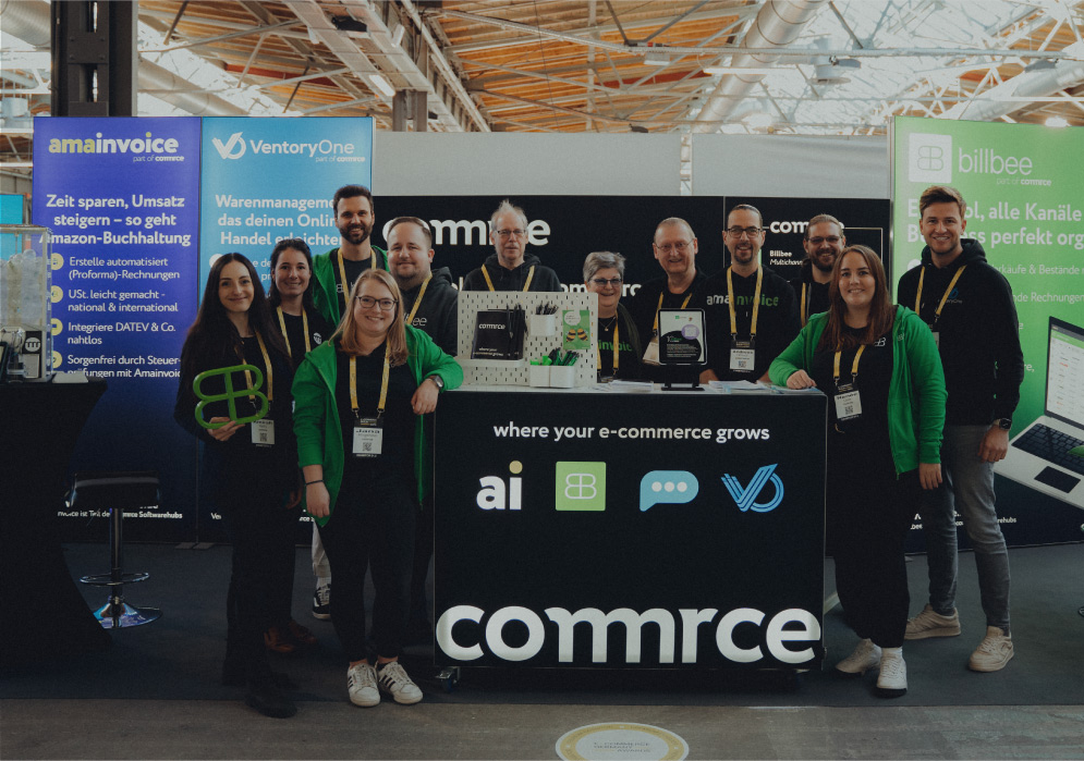 Gruppenfoto von elf Personen an einem Messestand mit Bannern von amainvoice, VentoryOne und billbee, die e-Commerce-Lösungen präsentieren.