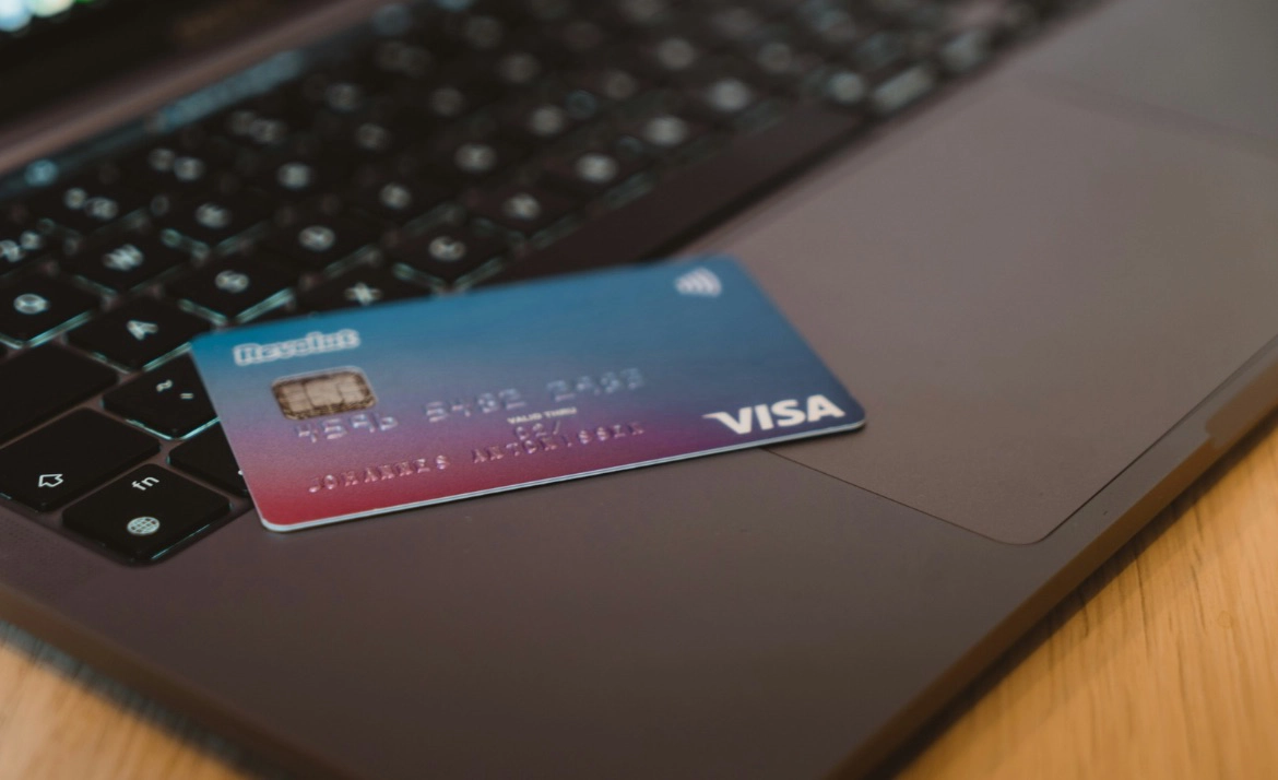 Kreditkarte mit Chip und VISA-Logo liegt auf der Tastatur eines Laptops