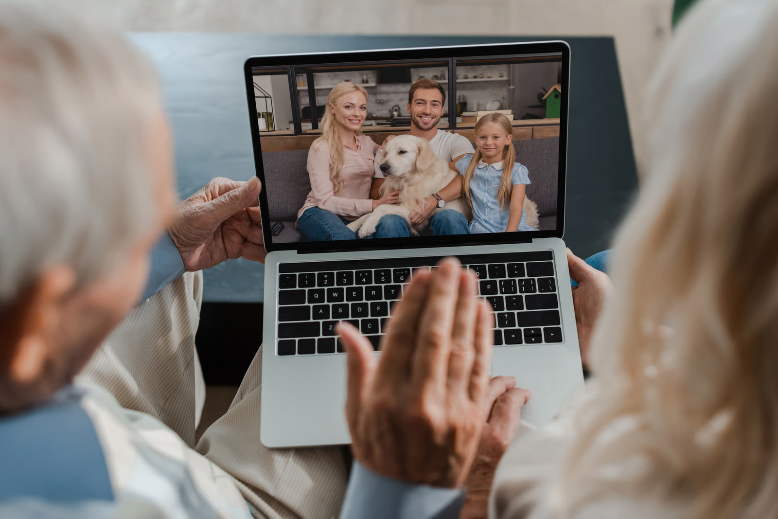Older couple viewing family photo on laptop, representing digital memories and legacy access