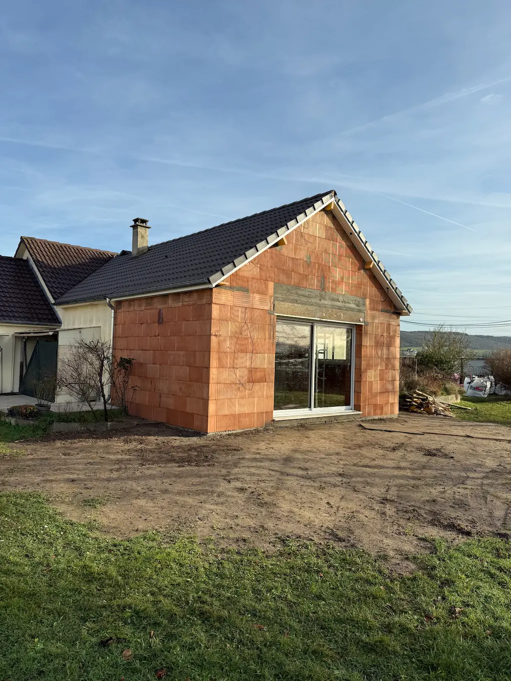 Extension en briques avec baie vitrée accolée à une maison existante