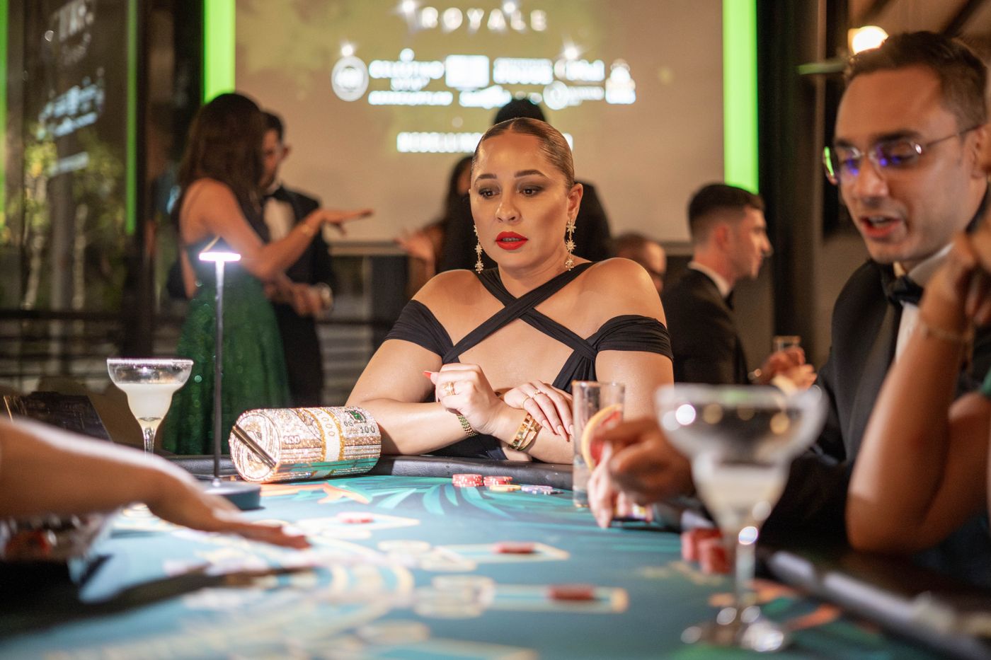 A guest with a martini at the blackjack table
