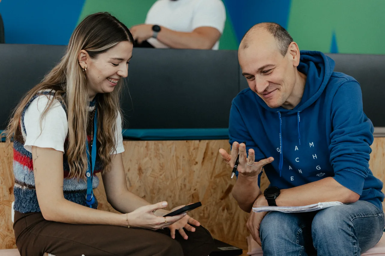 Two founders chatting on a couch in the Wayra office