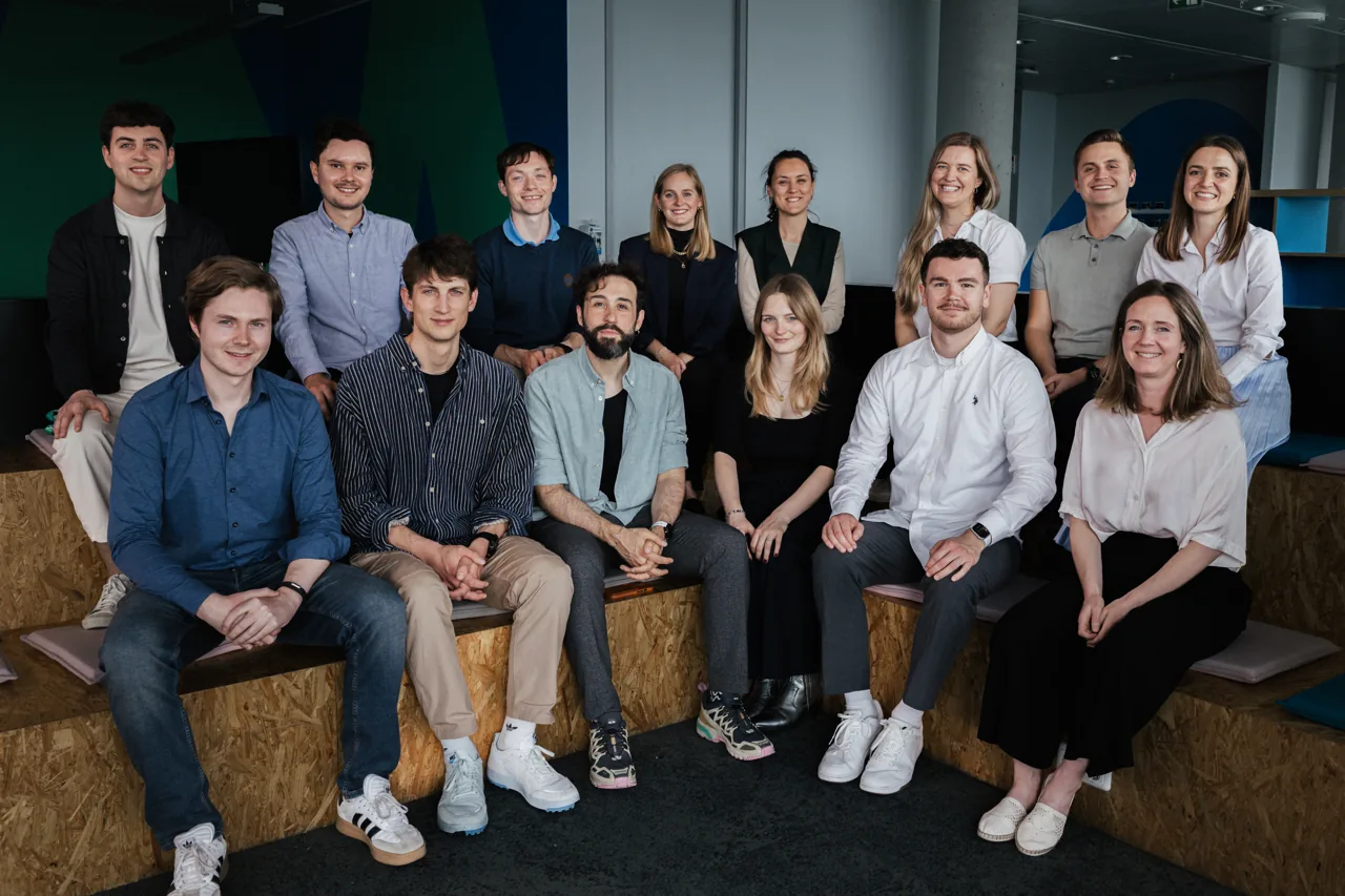 Group photo of the Wayra Germany team on wooden tiers in the office