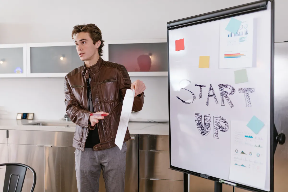 Founder presents a startup strategy on a flip chart during an accelerator programme