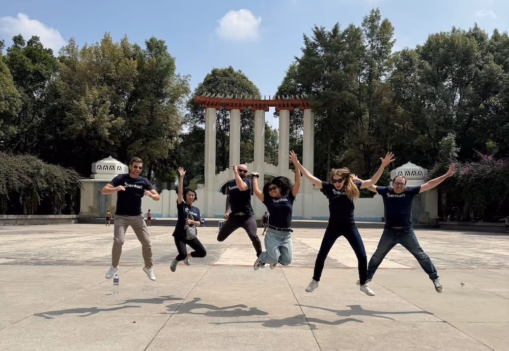 A group photo of the Centari team jumping in the air.
