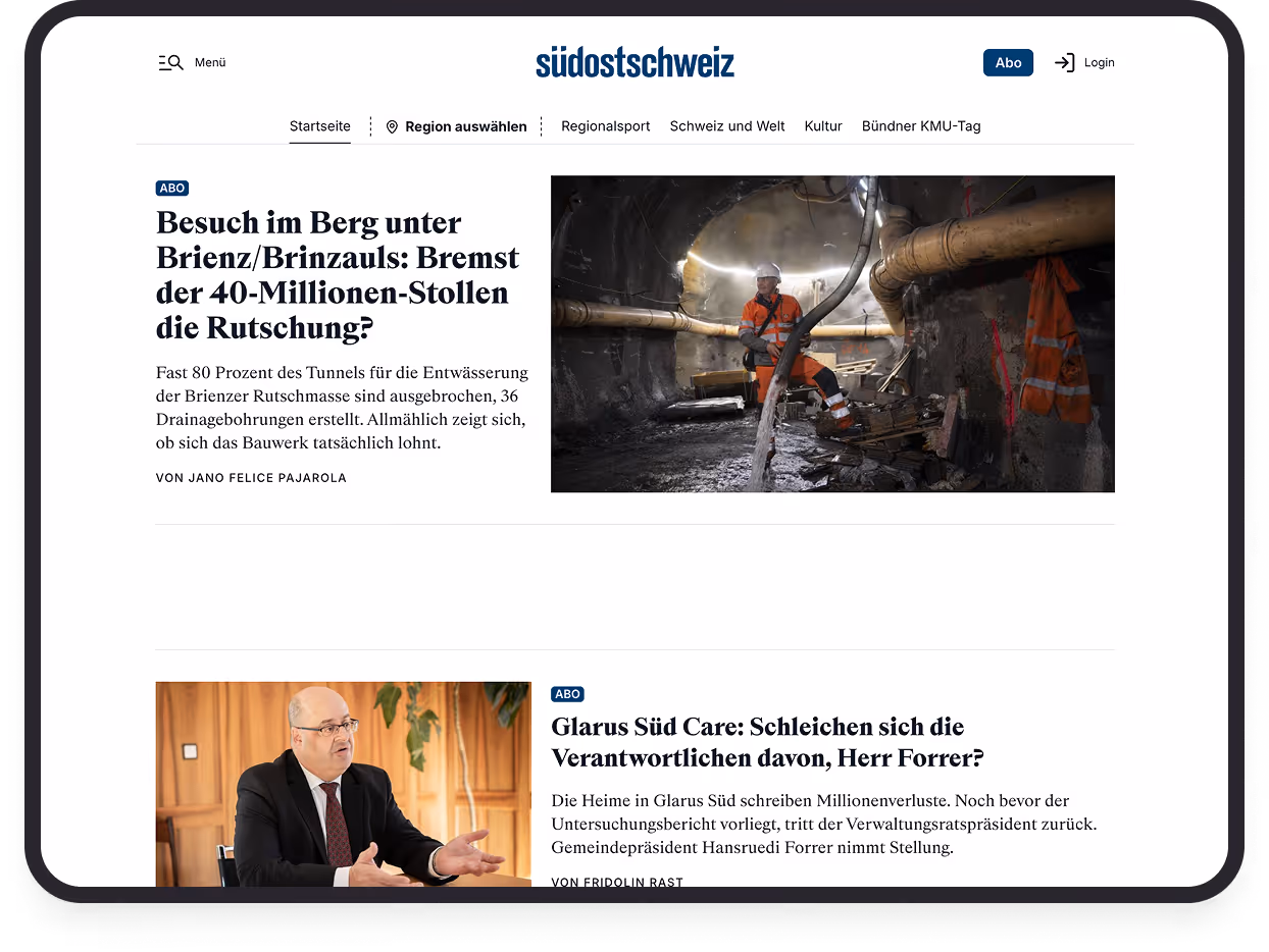 Tunnelarbeiter in orangefarbener Schutzkleidung sitzt in einem Tunnel unter Brienz/Brinzauls.