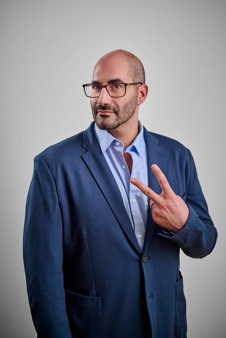 David Mahbub Of MACH9 posing for a photo making the peace sign. 