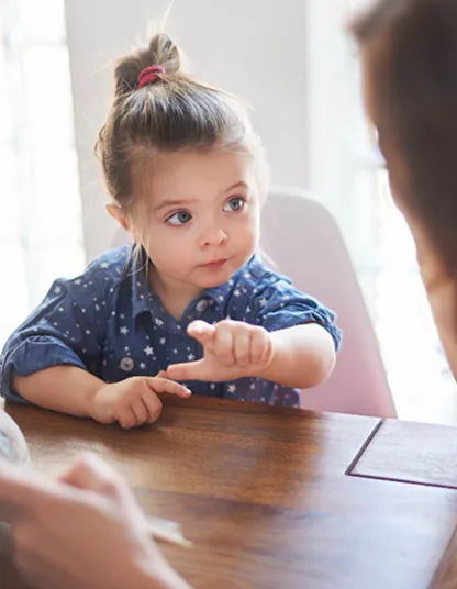 Devojčica pokazuje prstom 