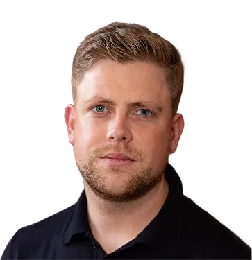 Portrait of a man with short light brown hair, blue eyes, light beard, and black collared shirt against a transparent background.
