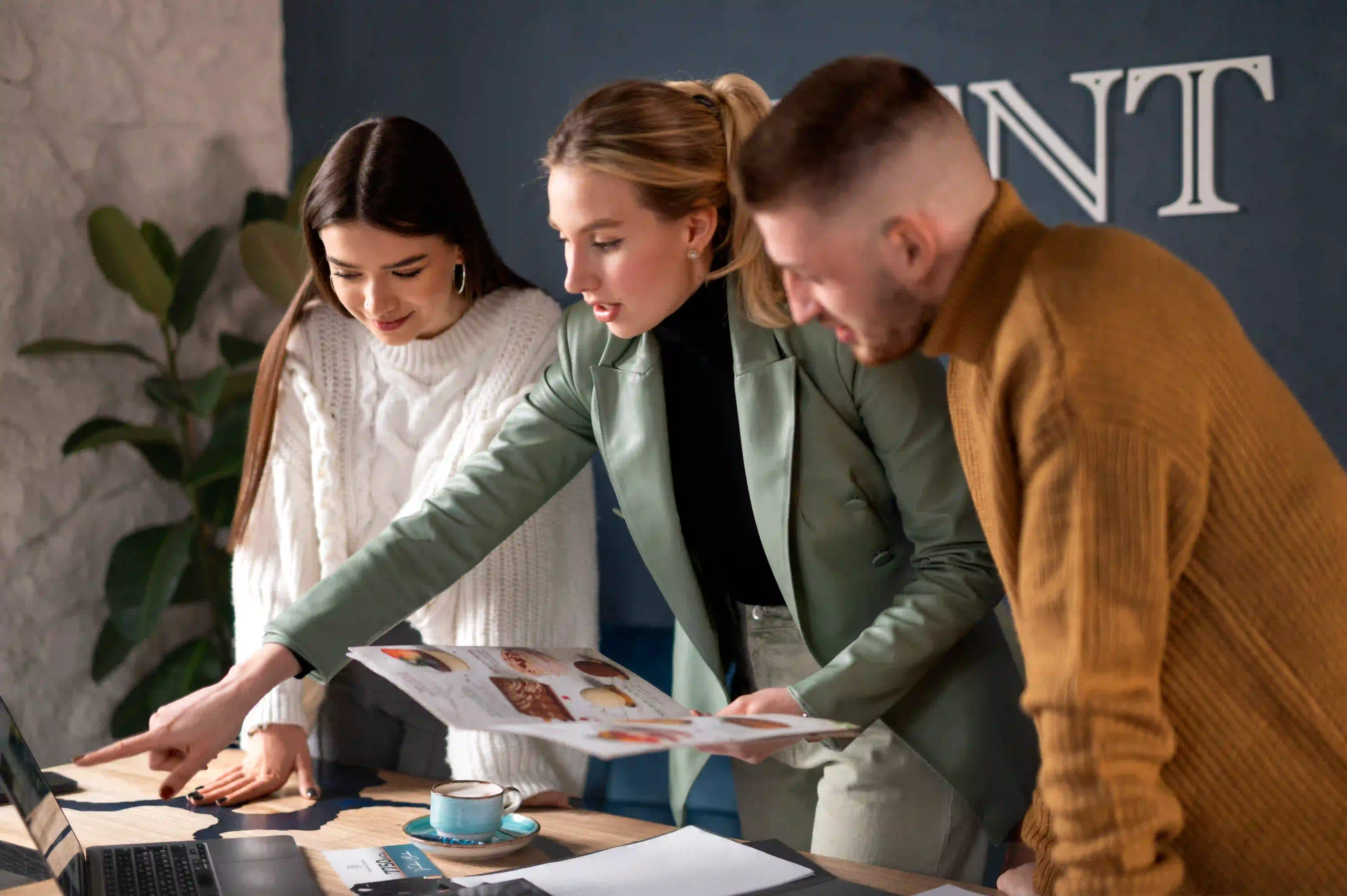 A corporate team reviewing printed materials and brand guidelines with their enterprise design partner.