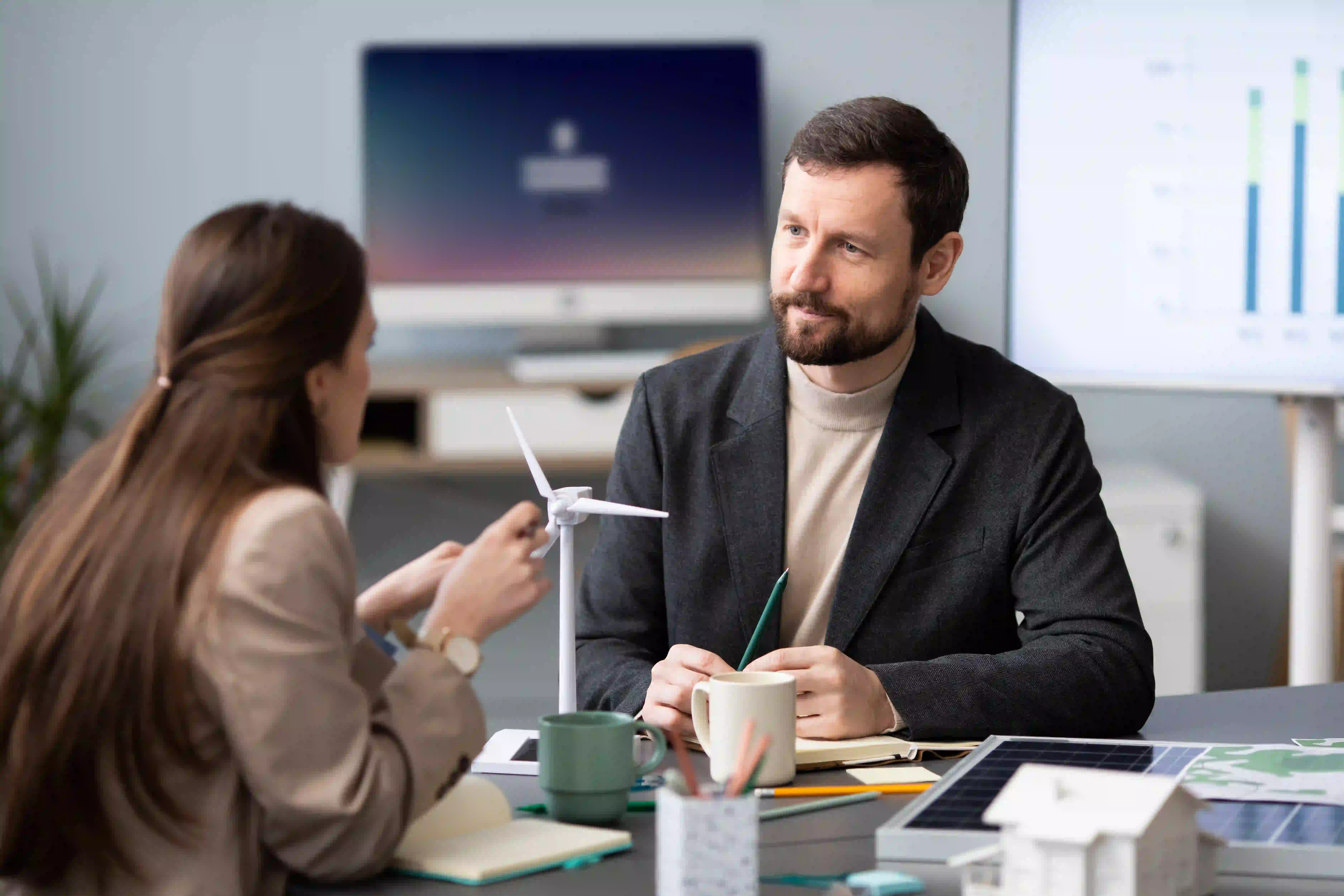 A sales representative discussing strategy with a B2B buyer, highlighting the evolving role of sales in validating AI-generated research.