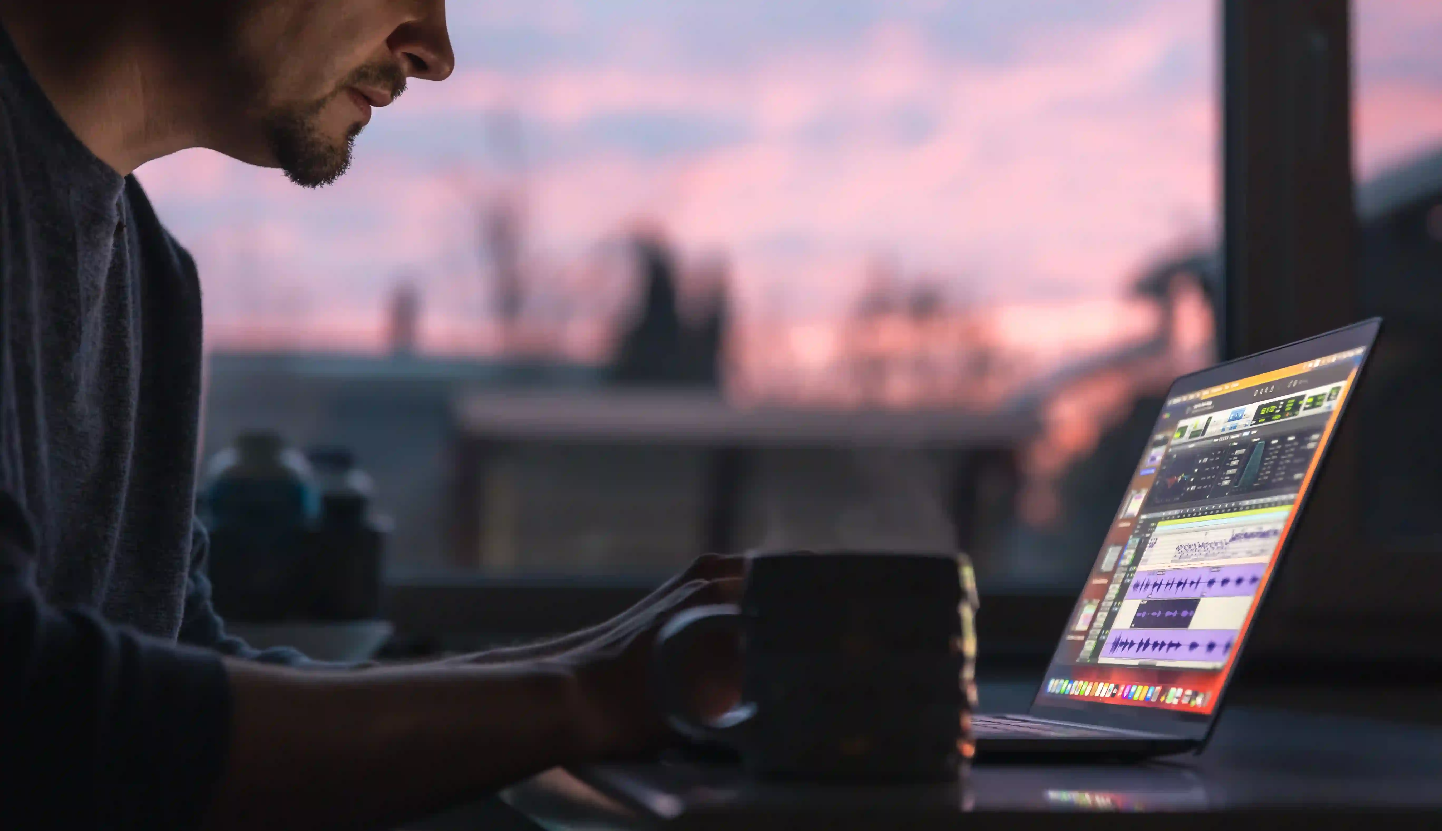A professional video editor working on a post-production timeline on a laptop, illustrating end-to-end capabilities in a fair corporate video engagement