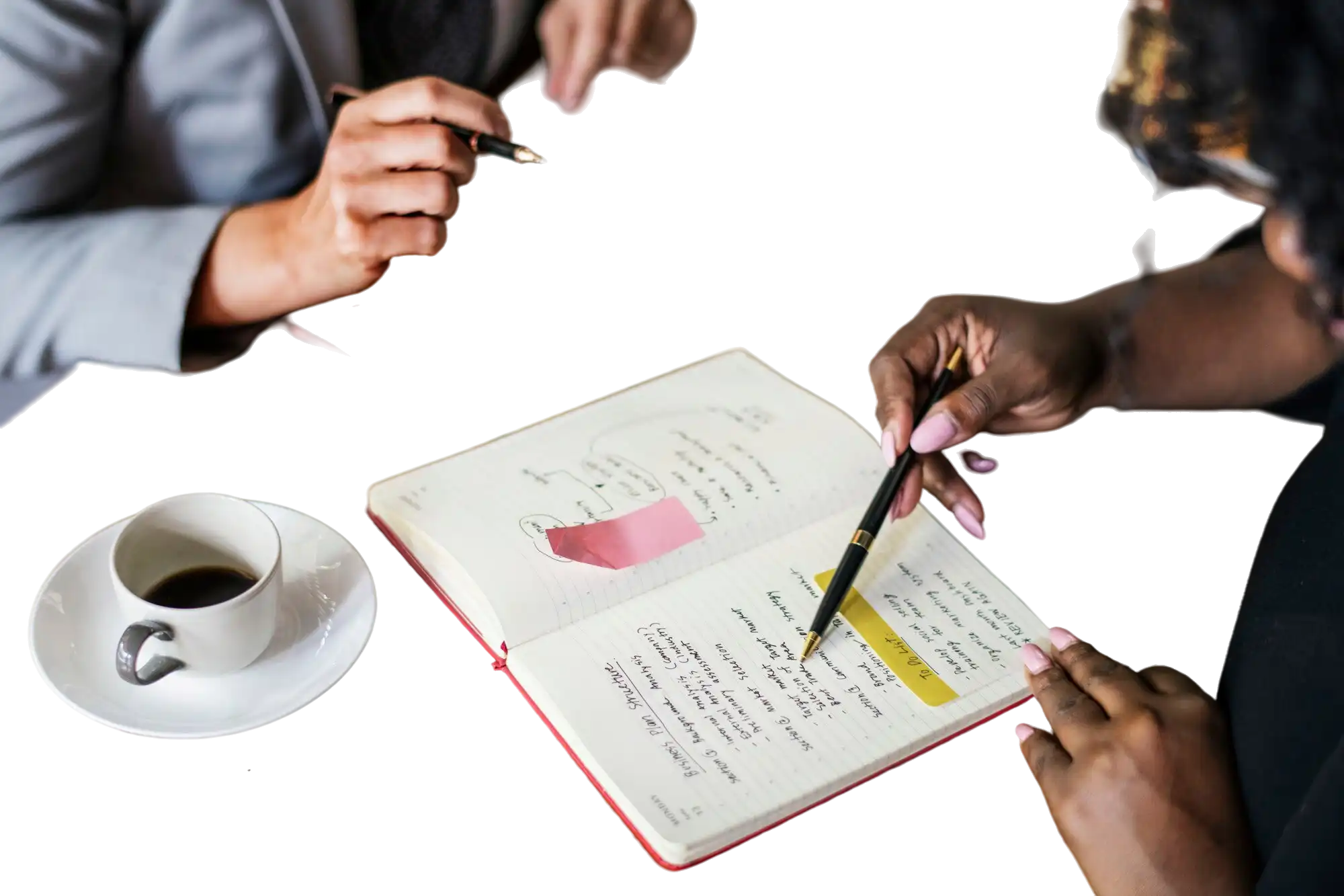 Two marketing professionals taking notes in a planner, representing the internal alignment required before briefing a video ad agency in India