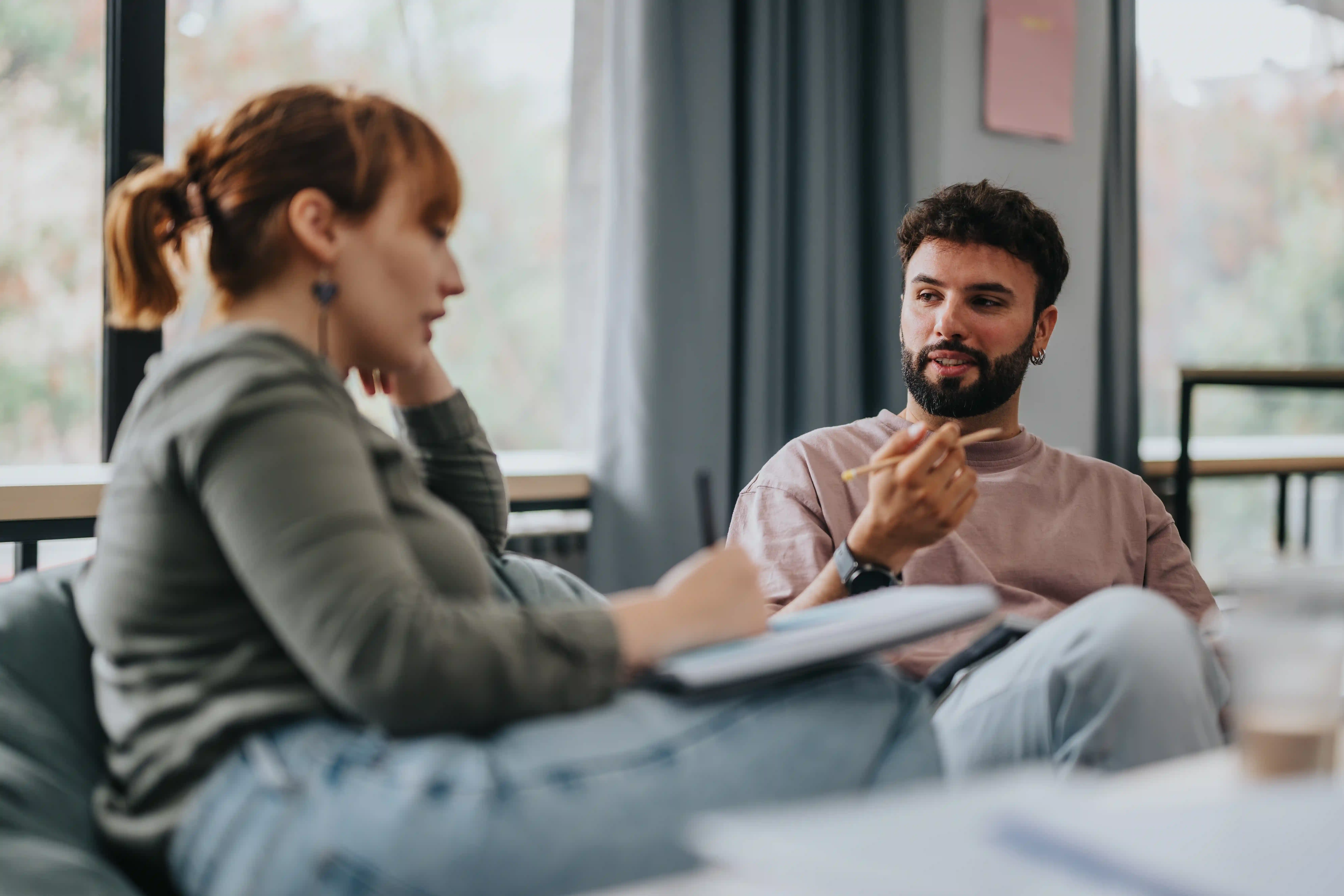 A marketing strategist interviewing a subject-matter expert in a relaxed setting, illustrating how to build a lightweight system for human-led B2B LinkedIn video.