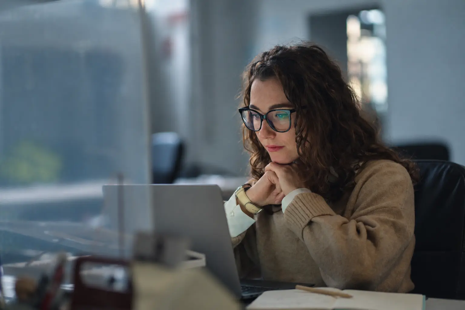 A B2B marketing professional analyzing data on a laptop, illustrating how a true strategy differs from basic planning and execution.