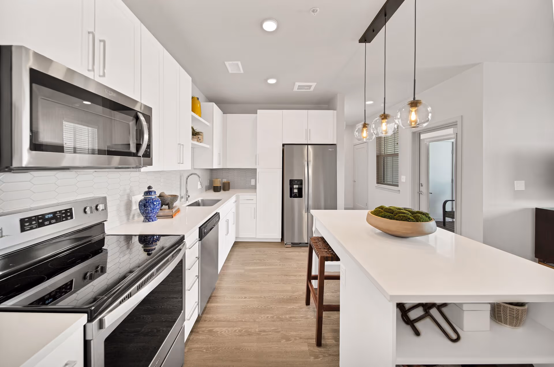 Furnished kitchen with stainless steel appliances and quartz countertops