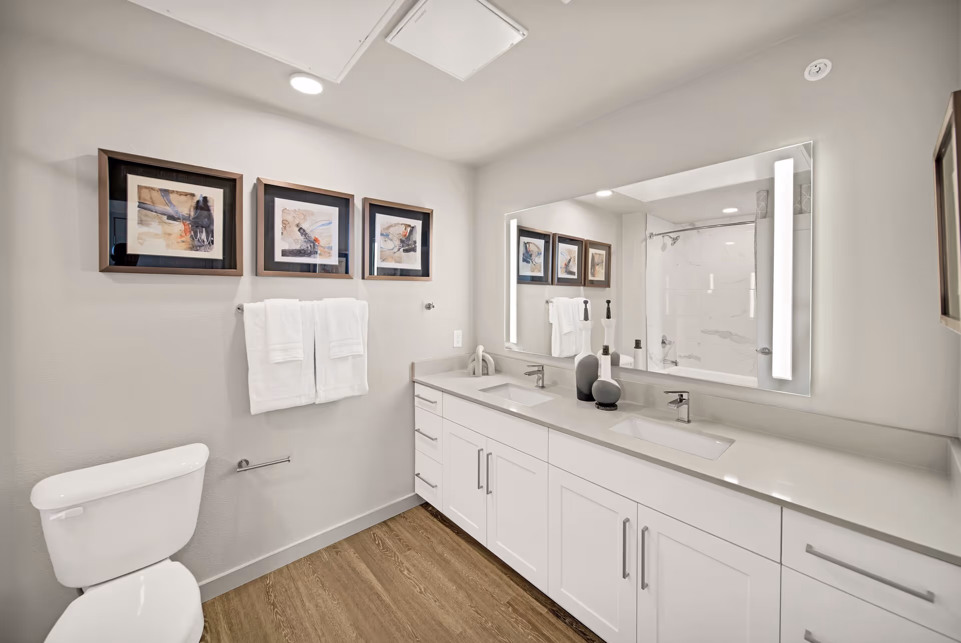 Bathroom with double vanity sink and toilet