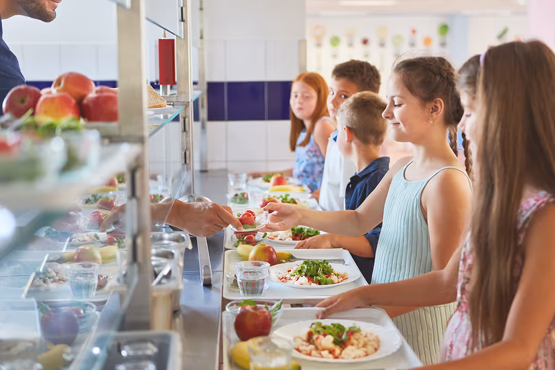 A group of students getting lunch at school.