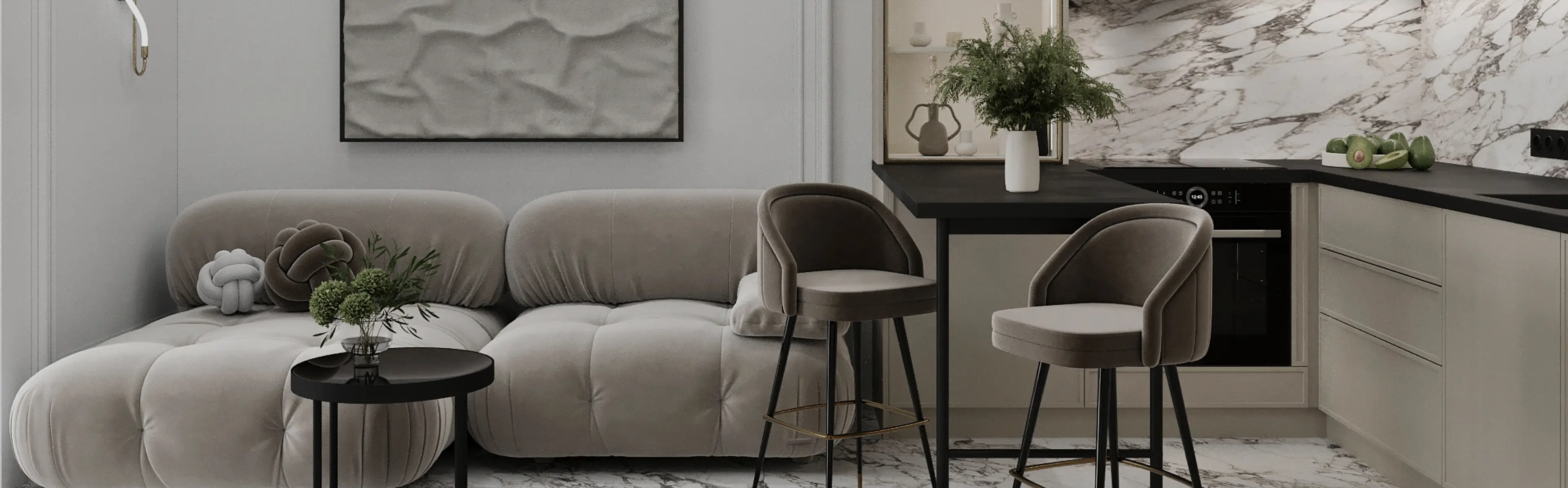 Modern living room with tufted grey sofa, black round side table, and kitchen bar with two grey chairs.