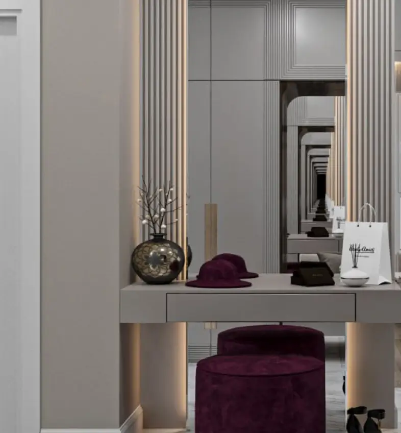 Modern vanity table with purple stool, decorative vase, hat, and mirrored wall creating infinite reflections.