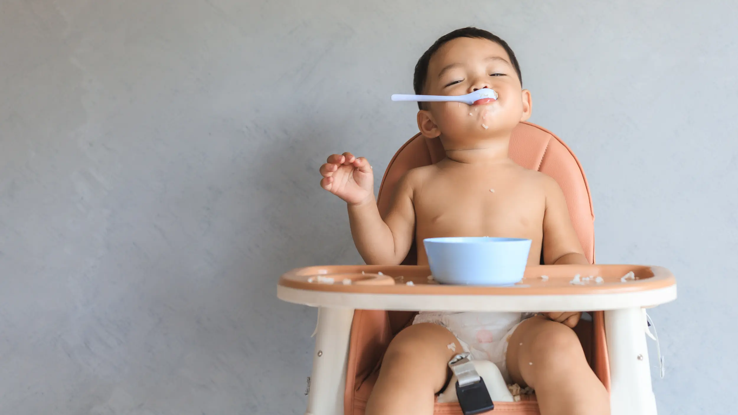 baby in a highchair eating