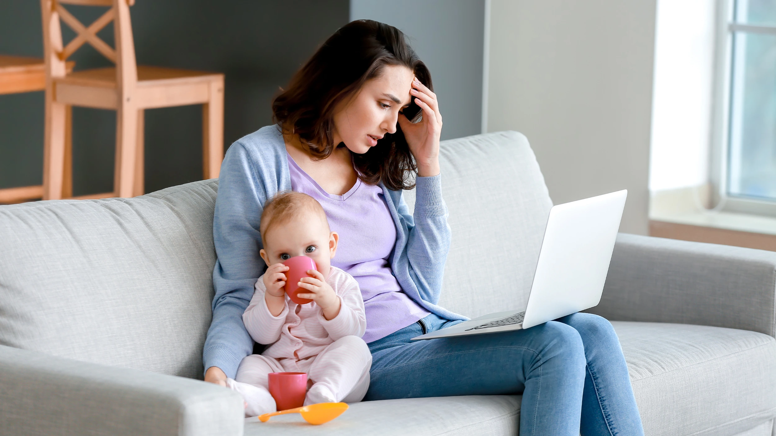 postpartum mom sitting with her baby