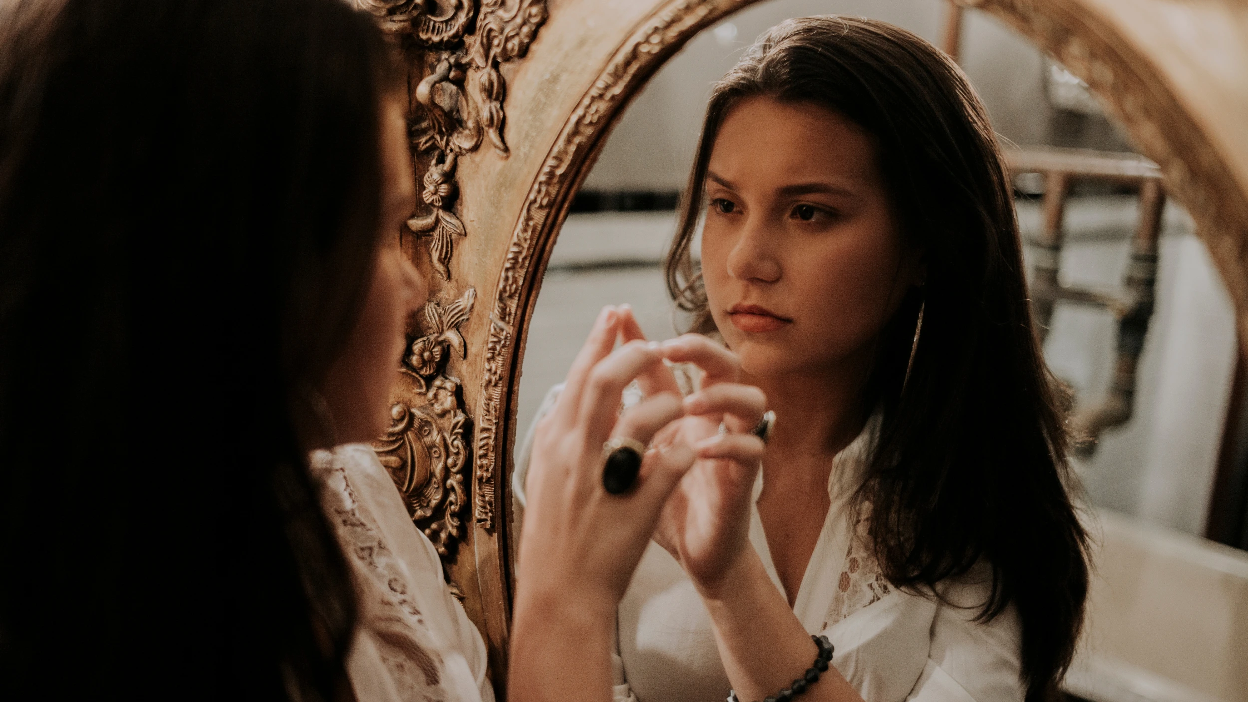 women with bad body image looking in the mirror